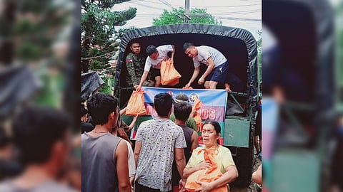 ONE Meralco Foundation volunteers hand relief packs to residents of Rodriguez, Rizal affected by flood last week.
