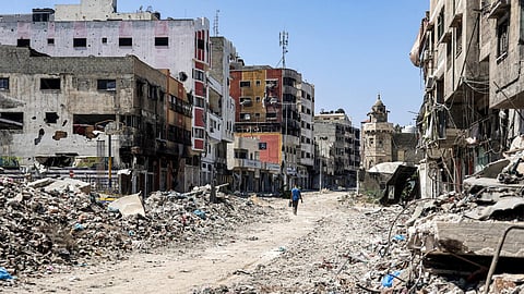 A man walks past rubble along a street in the Tuffah district in the east of Gaza City on July 8, 2024 