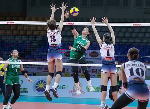 CLYDEL Catarig of Saint Benilde attacks the defense of Rhea dela Cruz and Judiel Nitura of Letran during Game 1 of their SSL National Invitationals best-of-three battle for bronze series. The Lady Blazers prevailed, 21-25, 25-21, 25-16, 25-17.     