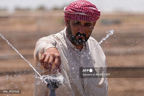 A farmer adjusts an irrigation sprinkler in a rice field in Mishkhab in Iraq's Najaf province on July 8, 2024, as four consecutive years of drought and declining rainfall have strangled rice production in the country. Iraq, still recovering from years of war and chaos, is one of the five countries most impacted by some effects of climate change, according to the United Nations with Iraqi farmers defying a relentless drought by using tougher seeds and water-saving irrigation techniques, as well as receiving support from the agriculture ministry whose experts have been developing innovative methods to save the country's rice production.
