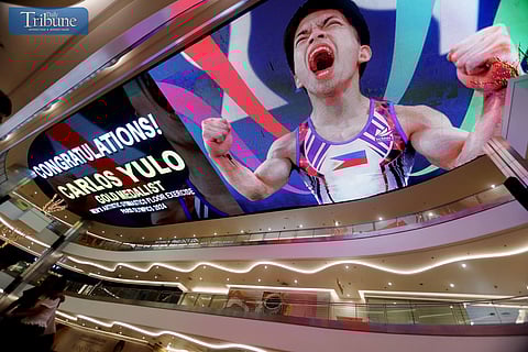 LOOK: A congratulatory message to Filipino gymnast Carlos Yulo is seen at the Quantum Skyview of Gateway Mall 2, Araneta City in Quezon City, on 5 August 2024, for his two-gold-medal win in the Paris 2024 Olympics men's artistic gymnastics floor exercise and men's vault. Yulo is the first male and second gold medalist in the country's Summer Olympics history.