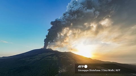 An aerial view shows a plume of ashes during an eruption of the Mount Etna volcano early on August 4, 2024 in Sicily.