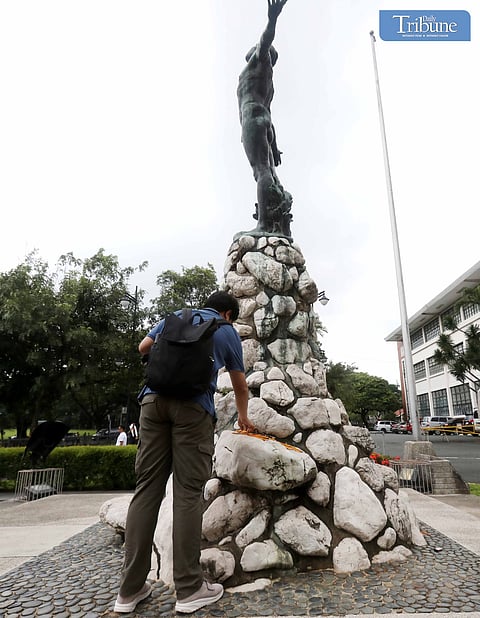 LOOK: UPCAT takers break their pencils after the exam and place them on the base of the Oblation at the University of the Philippines - Diliman in Quezon City on Sunday, 11 August 2024. 