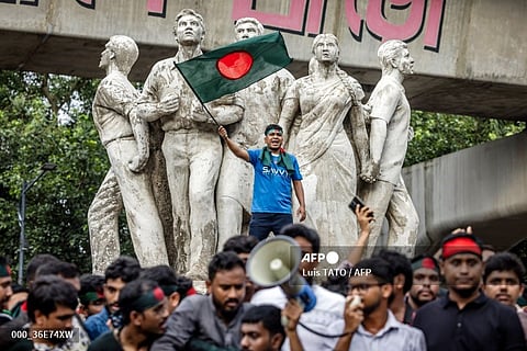 (FILE PHOTO) A student (C) waving Bangladesh's national flag, chants slogans during a protest to demand accountability and trial against the country's ousted Prime Minister Sheikh Hasina, near Dhaka University in the capital on August 12, 2024. Bangladesh was experiencing a "student-led revolution" after the ouster of premier Sheikh Hasina, the South Asian country's new interim leader Muhammad Yunus said.
