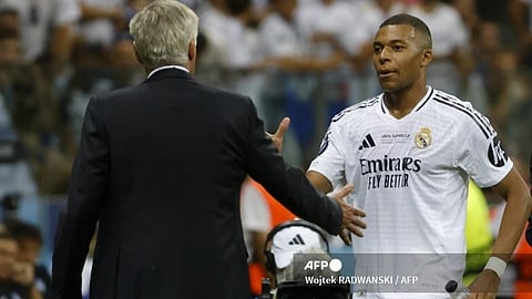 Real Madrid's French forward #09 Kylian Mbappe shakes hands with Real Madrid's Italian coach Carlo Ancelotti after being substituted during the UEFA Super Cup football match between Real Madrid and Atalanta BC in Warsaw, on 14 August 2024.