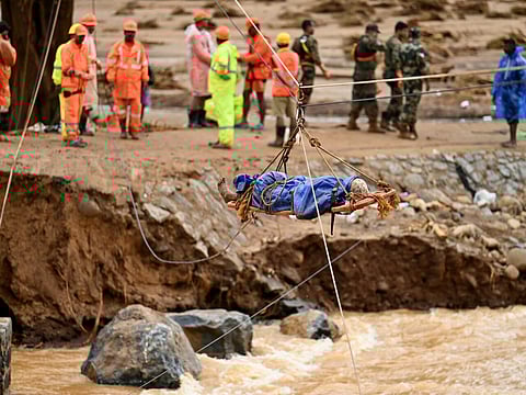 Rescuers retrieve the body of one of the more than 200 people killed in landslides triggered by intense rains in India's southern state of Kerala in July 