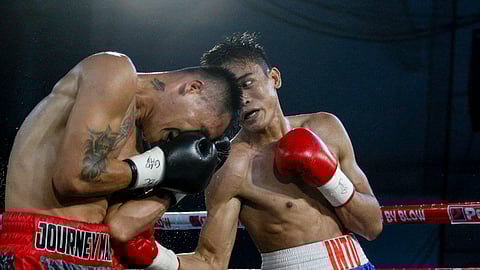 JERALD Into (right) bangs the body of veteran Mark John Yap on Thursday night during Manny Pacquiao Presents Blow-By-Blow at the Cantilan Municipal Gymnasium in Cantilan, Surigao del Sur.
