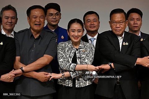 LOOK: Pheu Thai party leader Paetongtarn Shinawatra (front C), known by her nickname "Ung Ing" and the youngest daughter of former prime minister Thaksin Shinawatra, joins hands with coalition party leaders at a press conference as she is named the candidate to be Thailand's next prime minister at Shinawatra Tower in Bangkok on August 15, 2024. Thailand's Pheu Thai party chose Paetongtarn Shinawatra, the daughter of billionaire ex-PM Thaksin, as its candidate for prime minister, it said August 15, a day after a court dismissed the incumbent premier in an ethics case. | 📸 Lillian SUWANRUMPHA / AFP