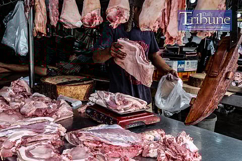A MEAT vendor chops a pork belly upon order on August 18, 2024. The spread of African Swine Fever (ASF) in the Philippines has led to panic among hog raisers, prompting some to sell infected pigs to traders, further worsening the situation. The Bureau of Animal Industry (BAI) has intercepted several trucks carrying pigs from ASF-hit areas, and the Department of Agriculture (DA) suspects that these traders are a major source of the virus's spread. The government is set to start vaccinating pigs soon to control the outbreak, though concerns remain about the limited availability and effectiveness of vaccines. If the situation deteriorates, the government may consider importing pigs to address potential shortages. PHOTO BY YUMMIE DINGDING
