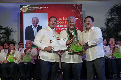 SMPC chairperson and CEO Isidro A. Consunji receives his award at the Bahay ng Alumni, UP Diliman, Quezon City.