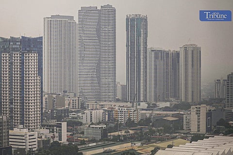 The Mandaluyong and Ortigas skyline is covered in smog at 6:44 a.m. on Monday.