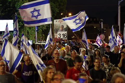 Relatives and supporters of Israelis held hostage by Palestinian militants in Gaza since the October 7 attacks, wave flags as they demonstrate calling for their release in the port city of Haifa on August 17, 2024, amid the ongoing conflict between Israel and the militant Hamas movement. 

