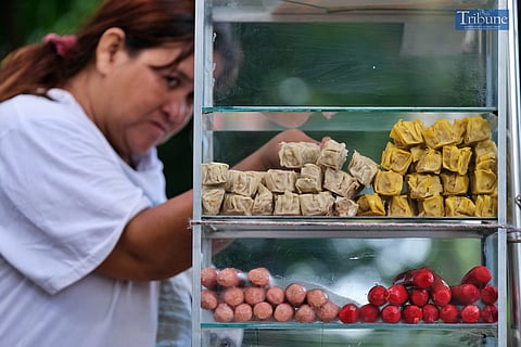 LOOK: A vendor prepares her products while waiting for customers at her stand at Luneta Park on Thursday, 22 August 2024. 
