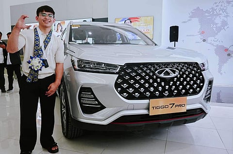 Olympic double gold medalist Carlos Yulo beams with pride after getting the keys to a brand new Chery Tiggo 7 Pro.