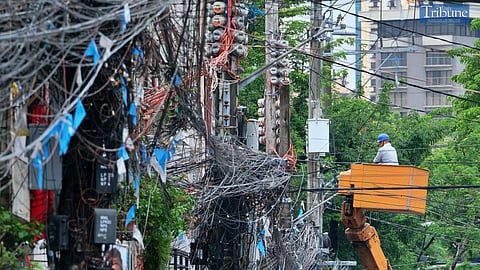 LOOK: A lineman installs a new electric line on a utility pole in Malate, Manila, on Wednesday, 28 August 2024. 