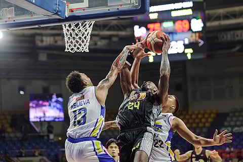 TNT import Rondae Hollis-Jefferson battles for the rebound against Magnolia's Calvin Abueva and Zav Lucero during their PBA Governors' Cup match.  