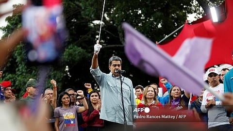 Maduro in a crowd raising sword