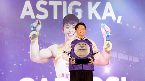 Carlos Yulo on stage accepting award