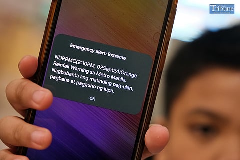 LOOK: A child looks at his phone as the National Disaster Risk Reduction and Management Council issues an emergency alert on Monday, 2 September 2024. 