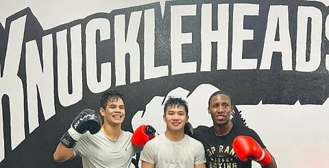 Undefeated super-bantam Carl Jammes Martin (middle) gets a helping hand from sparmates Jose Antonio Segura (left) and Bruce Carrington in Las Vegas. 