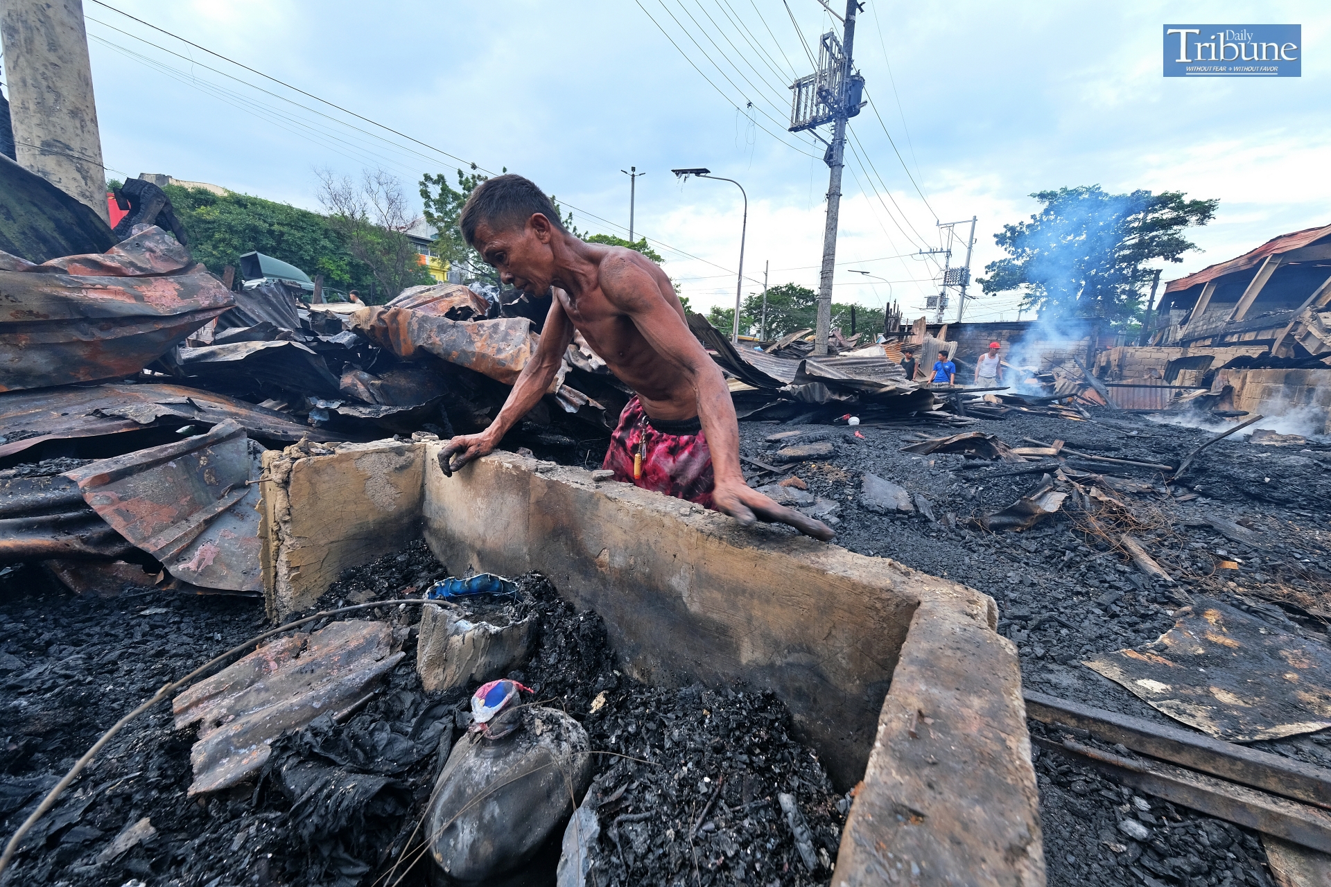 LOOK: Fire victims search among the burned remnants of their houses in Tondo, Manila on Sunday, 15 September 2024. The fire incident, which occurred a day before, has resulted in thousands of families losing their homes. 