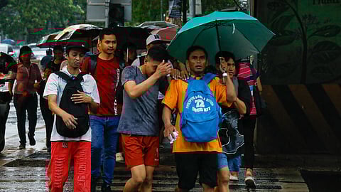 (FILES) Motorists and pedestrians experienced heavy rain on June 21, 2024. PAGASA said that some parts of Luzon may experience heavy rainfall due to localized thunderstorms.