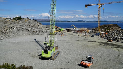 (FILES) A photo taken on 21 June 2021 in Oygarden near Bergen, Norway, shows cranes and vehicles at a construction site at the start of construction work for a terminal that will collect liquefied carbon dioxide CO2, which will arrive by ship from industrial facilities in Europe and will run through a pipeline into geological formations deep beneath the sea bed so that it doesn't contribute to global warming. On the icy shores of the North Sea, a "graveyard" is raising the hopes of climate experts: soon, the site will house a -- small -- portion of the CO2 emitted by European industry, preventing it from ending up in the atmosphere.
