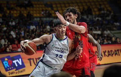 Justin Arana of Converge turns June Mar Fajardo of San Miguel Beer into a believer during Game 1 of their PBA Governors’ Cup best-of-five quarterfinal series late Thursday at the Ninoy Aquino Stadium.