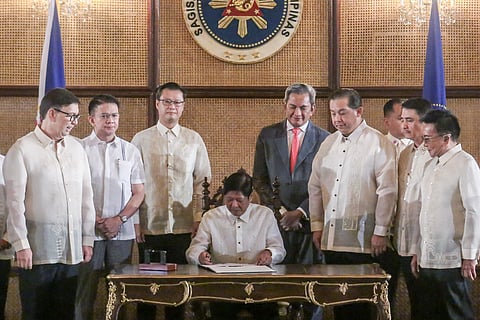 PRESIDENT Ferdinand Marcos Jr. signs the VAT Digital Service Law at Malacañang Palace on Wednesday. Serving as witnesses were Finance Secretary Ralph Recto, Senate President Francis G. Escudero, Senator Sherwin Gatchalian, Albay 2nd District Representative Joey Salceda, House Speaker Ferdinand Martin G. Romualdez, Aklan 2nd District Rep. Teodorico T. Haresco, and other government officials. 