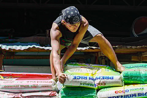 Workers unload sacks of rice from a delivery truck at the Bagong Palengke, Taytay, Rizal on Wednesday, 25 September. President Marcos on Tuesday said that he is confident rice prices in the Philippines will drop similar to nearby countries.