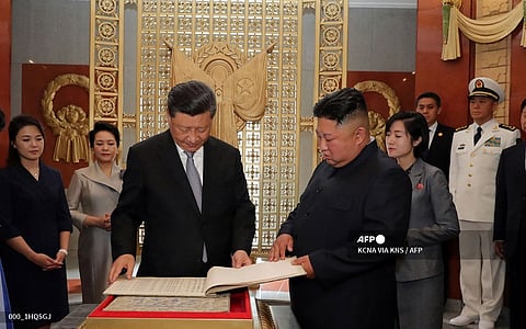 China's President Xi Jinping (center) and his wife Peng Liyuan visits the friendship tower with North Korean leader Kim Jong Un and his wife Ri Sol-Ju in Pyongyang.