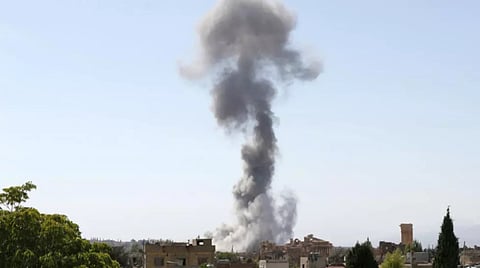 Smoke billows following an Israeli airstrike near the ruins of the ancient Roman Temple of Baachus in Lebanon's eastern city of Baalbek in the Bekaa valley 
