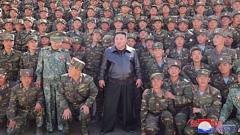 This picture taken on October 2, 2024 shows North Korea's leader Kim Jong-un (C) posing with troops. 