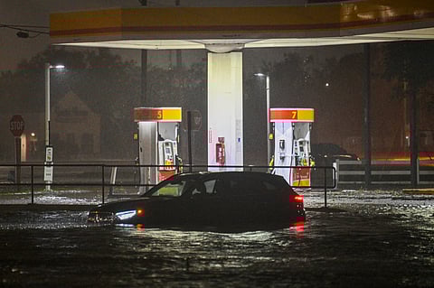 A vehicule is stranded on a water-flooded street after Hurricane Milton made landfall in Brandon, Florida on October 9, 2024. Milton made landfall in Florida 9 October 2024 as an "extremely dangerous" Category 3 hurricane, packing life-threatening storm surge, extreme winds and flash flooding, the National Hurricane Center (NHC) said. "Data indicate the eye of Hurricane Milton has made landfall near Siesta Key in Sarasota County along the west coast of Florida," the NHC said in an 8:30 pm (0030 GMT Thursday) bulletin.