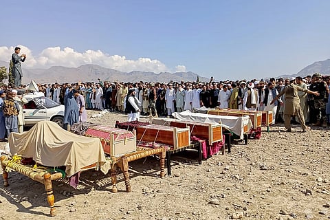 Sunni Muslim men gather to offer prayers during the funeral ceremony for victims who were killed in a tribal clash, at Kurram district in Khyber Pakhtunkhwa province.