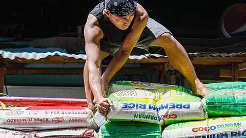 (FILE PHOTO) Workers unload sacks of rice from a delivery truck at the Bagong Palengke, Taytay, Rizal on Wednesday, 25 September. President Marcos on Tuesday said that he is confident rice prices in the Philippines will drop similar to nearby countries.