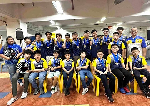 Members of the Xavier School chess squad pose after asserting their dominance in the Interscholastic Sports Association chess tournament over the weekend.
