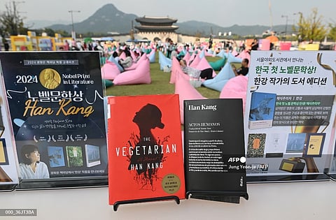 Books by South Korean author Han Kang, who won the 2024 Nobel Prize in Literature, are displayed during an outdoor library event at Gwanghwamun Square in central Seoul on October 11, 2024. From the president to K-pop megastars BTS, South Korea erupted into celebration on October 10, after "The Vegetarian" author Han Kang won the country's first Nobel Prize for literature.

