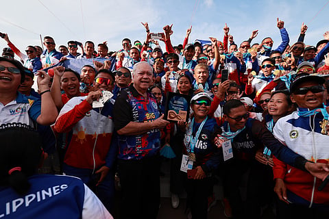 The Philippine team celebrates after bagging the overall title in the just-concluded ICF World Dragon Boat Championships with host Puerto Princesa City Mayor Lucilo Bayron (center) receiving the trophy.