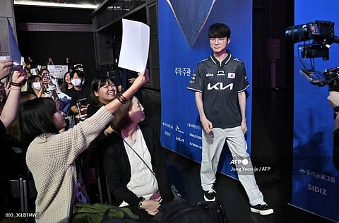 E-sports League of Legends South Korean national team player Lee "Faker" Sang-hyeok (R) walks past supporters during a fan meeting event ahead of the upcoming Asian Games in Gwangmyeong on September 11, 2023. When he was younger, Lee Sang-hyeok just wanted to be a “normal kid”. But that was not to be, and today he is an icon in his homeland, South Korea, and an esport legend, known worldwide simply as “Faker”.
Jung Yeon-je / AFP