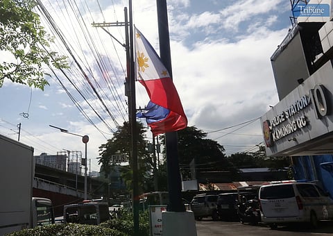 The Philippine flag is half-masted at Quezon City Police District Station 10. President Ferdinand Marcos Jr. declared 4 November a Day of National Mourning in solidarity with the bereaved families and loved ones of those who perished due to the onslaught of severe tropical storm Kristine.