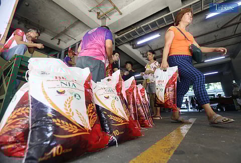 People purchase 10 kilos of rice at 29 pesos per kilo at the National Irrigation Administration (NIA) Kadiwa store in Quezon City, supporting President Ferdinand "Bongbong" Marcos Jr.'s call for affordable food for Filipinos nationwide.
