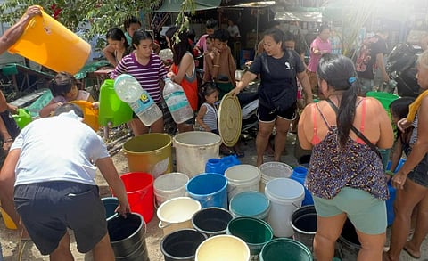 RESIDENTS of Barangay Labangon in Cebu City get water ration during a supply shortage.