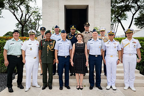 U.S. Ambassador MaryKay Carlson joins service members from different nations to honor veterans at the Manila American Cemetery.