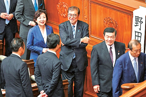 Japan’s Prime Minister Shigeru Ishiba (center) queues up to cast his vote in the second round of a parliamentary vote to nominate a prime minister following the 27 October general election during a special session of parliament in Tokyo. 