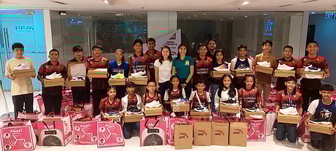 Maxine Esteban and Milka Romero (middle) put smile to the faces of the young athletes after donating running shoes, study lamps and biscuits to the Olongapo Junior Tracksters over the weekend.    