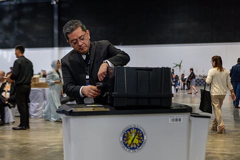 Comelec Chair George Garcia shows how to use the new ACMs, set to be used for the first time in the upcoming 2025 midterm elections