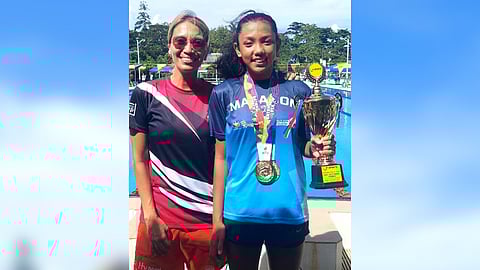 Swimmer Sophia Garra beams with pride alongside her coach Jenny Guerrero after a four-gold performance in the Batang Pinoy in Palawan.