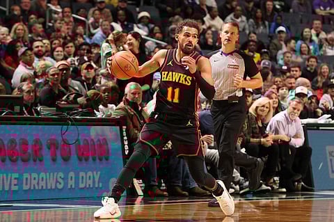 CHARLOTTE, NC - 30 NOVEMBER: Trae Young #11 of the Atlanta Hawks dribbles the ball during the game against the Charlotte Hornets at Spectrum Center in Charlotte, North Carolina. 