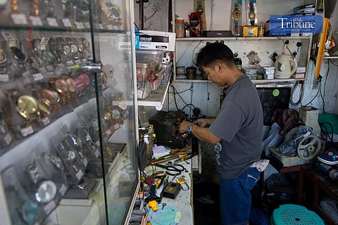 Evener Toribio, 43, is busy at his repair shop on Vi llongco Street in Commonwealth, Quezon City, on 6 December, 2024.  

Toribio said he has been selling and repairing watches for 22 years. He shared that the cost for repairs goes for as low as P30, but the price varies depending on whether replacement is needed or more work needs to be done to fix the device. His shop also offers key duplication and shoe repair services.  

Through his work, Toribio is able to fund his two children’s education, who are both currently in junior high school.  

He said that his interest in this craft began when he was a teenager. Having only finished high school, Toribio was fortunate to receive a measly 2,300 pesos in capital from a relative to start his business.  

Years later, he now rents his own stall and has acquired various tools and machines to help him with his work.